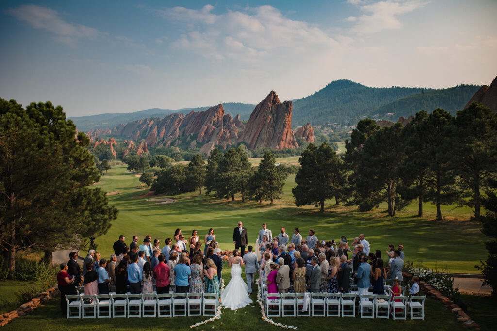 A Colorado bride is walked down the aisle by her father at Arrowhead Gold Course.