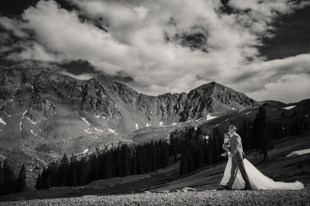 A Colorado bride walks with there father for the processional at her A-Basin wedding.