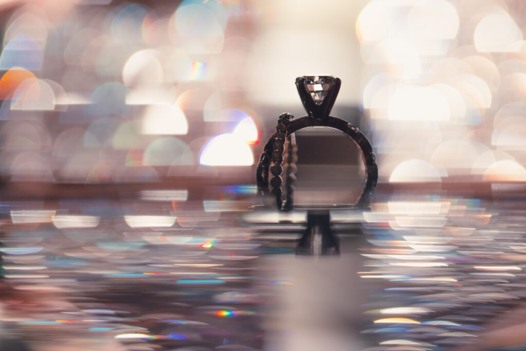 An artistic wedding ring photo with colored bokeh.